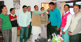 State BJP President Bishan Singh Chufal offers sweets to party workers in Pitthoragarh on Friday on the occasion of Divali.