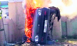 A car of a murder accused set on fire by an agitated mob in Dehradun on Thursday.