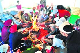 Shopkeepers perform a havan on Vishvakarma Day in Shimla