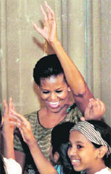 US First Lady Michelle Obama dances with the children