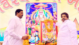 Minister for Revenue and Relief Raman Bhalla (R) takes part in pooja on the occasion of Vishwakarma Day in the Marble Market in Jammu on Saturday.