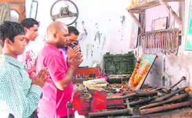 Workers pay tributes to Lord Vishkarma and worship the tools in Ludhiana on Saturday.