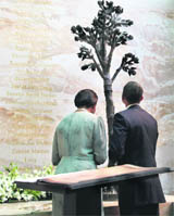 US President Barack Obama and First Lady Michelle Obama view the 26/11 memorial at the Taj Mahal Palace and Tower Hotel in Mumbai on Saturday.