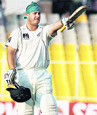 New Zealand's Jesse Ryder celebrates century against India during third day of the first Test in Ahmedabad on Saturday.