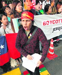 A Suu Kyi supporter rips apart a copy of Myanmars constitution at a demonstration outside the countrys embassy in Tokyo