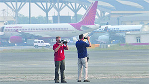 Protecting the first family of America: Men of the US Secret Services keep vigil at the Palam airforce station in New Delhi on Sunday before the arrival of US President Barack Obama and his wife Michelle Obama.