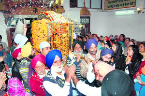 Devotees hold a nagar kirtan on the eve of Guru Granth Sahib Gurta Gaddi celebrations in Shimla on Sunday.