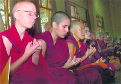Buddhist monks offer daily prayers at the Dalai Lama temple in McLeodganj on Sunday. 