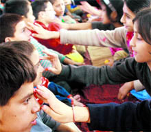 Children celebrate Bhai Duj at Bal Ashram in Jammu on Sunday
