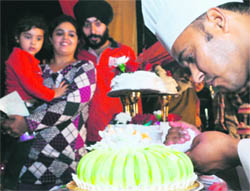 A chef gives final touches to a cake during the cake festival in one of the hotels in Ludhiana on Monday