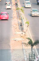 The broken fence divider near the Government College for Women posses danger
