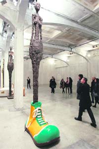 A man looks at a sculpture by US artist John Baldessari during a show at the Prada Foundation in Milan recently