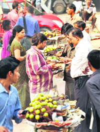 Despite a ban, the sale of cut fruits and other eatables continues unhindered near a metro station in Gurgaon.