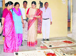 Judges of a Sanjhi competition have a look at participants creations in Sirsa.