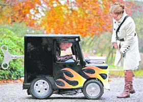 A woman watches Wind Up mini car on a street in Essen, Germany