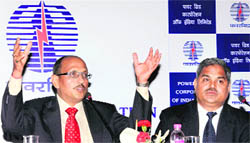 PowerGrid Corps Director I.S. Jha and Executive Director (Finance) RT Agarwal (R) at the announcment of opening of the company's FPO bid in Kolkata on Tuesday. 