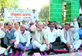 Workers of Left parties and other organisations stage a dharna in Dehradun on Tuesday.