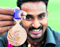 Ranjit Maheshwari shows the bronze medal that he won in the Commonwealth Games, in Ludhiana on Tuesday