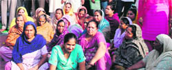 Residents sit on a dharna at Amloh on Tuesday