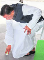 Congress MP Beni Prasad picks up a matchbox in Parliament.