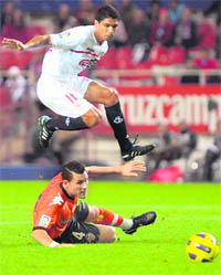 Sevilla's Renato (top) vies for the ball with Valencia's David Navarro (bottom) during their La Liga match at Ramon Sanchez Pizjuan stadium in Sevilla on Monday.