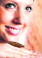 An employee poses with a gold, enamel, jewel and pearl-set automaton caterpillar at Sotheby's in Geneva on Wednesday. 