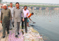 Public works minister Raj Kumar Chauhan with MP Mahabal Mishra inspects the Chhath ghat at ITO 