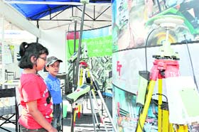 Children watch an exhibition on cartography on the sidelines of an international seminar in Dehradun