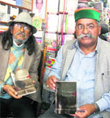 MLA Jot Singh Gunsola releases a book written by Sudhir Thapliyal (left) in Mussoorie on Wednesday. 