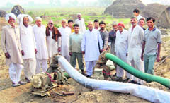 PIPE DREAM : Farmers of Sundana village with new pipes to pump out water from their fields under floodwaters
