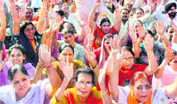 RSS activists raise slogans during a protest dharna against the linking of the organisation with terrorism, in Amritsar on Wednesday