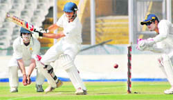 Uday Kaul cuts one to the fence against Karnataka in Mohali on Wednesday.