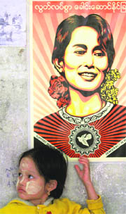 A girl stands under a Suu Kyi poster in Mae Sot on Wednesday.