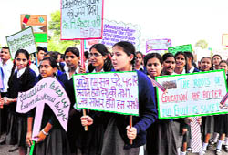 Students of Kendriya Vidyalaya, Sector 31, take part in a rally on the National Education Day in Chandigarh on Thursday