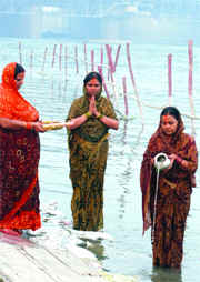 Devotees worship the sun god at the ghat.