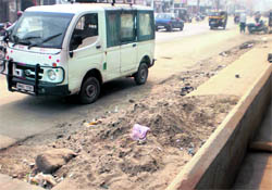 Heaps of sand accumulated along a road in Bhiwani