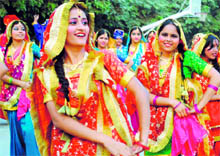 Girls perform a traditional dance while boys exhibit their skills with musical instruments during a cultural event at DAV School in Faridabad