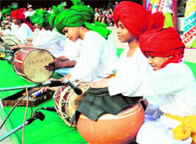 Girls perform a traditional dance while boys exhibit their skills with musical instruments during a cultural event at DAV School in Faridabad