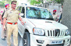 Police inspects the damaged vehicle outside SCD College in Ludhiana 