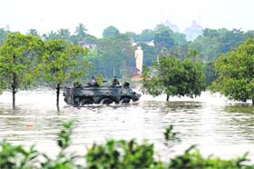 ALL IN A DAYS WORK! Lankan lawmakers are ferried in an amphibious armoured personnel carrier to Parliament, situated just outside Colombo