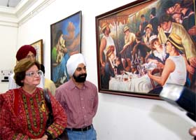 Pakistani artist Salima Hashmi takes a look at the paintings at an exhibition in Amritsar