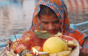 A woman devotee performs rituals on the occasion of Chhath Puja at the Durgiana Temple in Amritsar