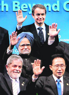 Prime Minister Manmohan Singh poses for a group photograph with other leaders during the G20 summit at the Coex convention centre in Seoul, South Korea on Friday. He said that funds from surplus nations can go to bridging the infrastructure gap in poor and emerging economies to avoid destabilisation. 