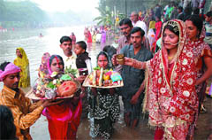 Devotees offering arghya to sun on Chath Puja on the bank of the Sirhind canal in Bathinda on Friday evening. 