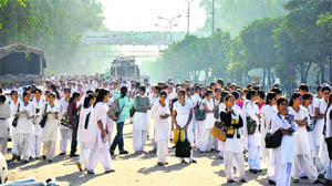 In the absence of bus shelters, girl students in Jammus Gandhi Nagar have to await transport facilities standing on the road, braving the sun and rain.
