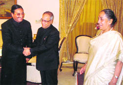 Union Minister of Finance Pranab Mukherjee with Governor Margaret Alva and Chief Minister Ramesh Pokhriyal Nishank at the Raj Bhawan in Dehradun on Saturday