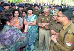 Women employees argue with police officers in Haridwar on Saturday