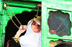A devotee touches a holy chain to seek blessings during the Urs of Sufi saint Shah-e Hamdan at Khankahi Moulla in downtown Srinagar on Saturday