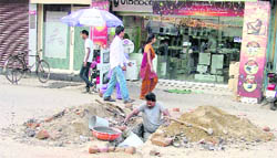 A worker digs a portion of the road connecting Mata Rani Chowk to Bhadaur House in Ludhiana. 