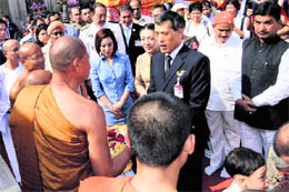 Prince Dipangkorn Rasmijoti of Thailand interacts with monks during a visit to the Mahabodhi Temple in Bodhgaya on Saturday